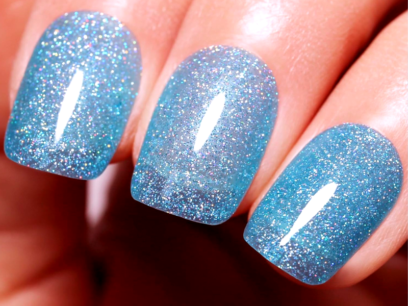 How can I add some sparkle to my light blue nails