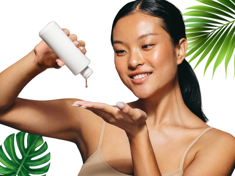 Smiling woman applying vegan skincare product with leaves.