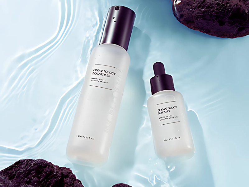 Two Incellderm Dermatology Booster products elegantly displayed on a serene water background with natural stone accents.