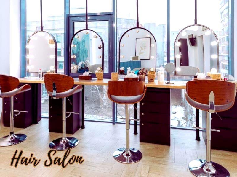 Modern hair salon with stylish chairs and mirrors, promoting ethical hair care practices for a sustainable future.