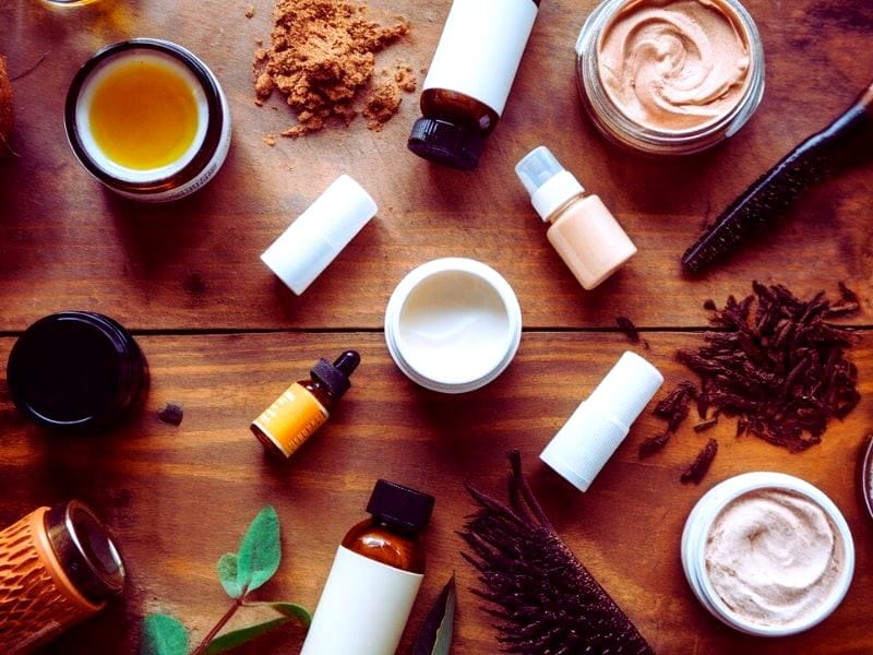 Flat lay of natural hair care products emphasizing the difference between organic and vegan hair care options for salons.