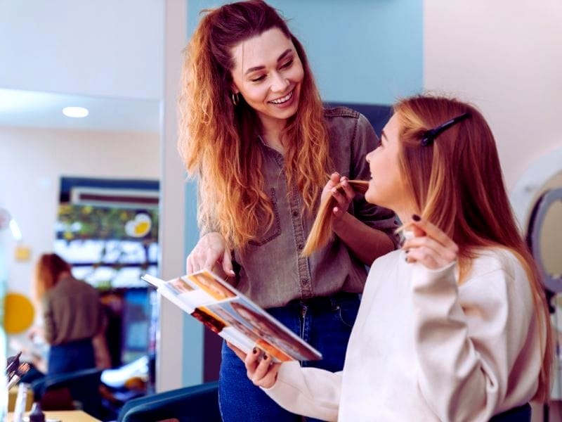 Stylists discussing haircare options to boost salon business growth and enhance client satisfaction.