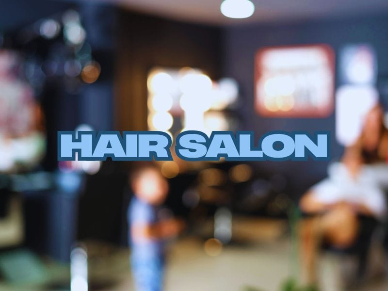 Blurry interior of a busy hair salon with glowing mirrors and people, featuring 'Hair Salon' text overlay.