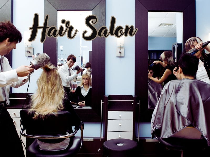 Busy hair salon scene with multiple hairstylists blow-drying clients' hair. Large mirrors reflect the modern interior