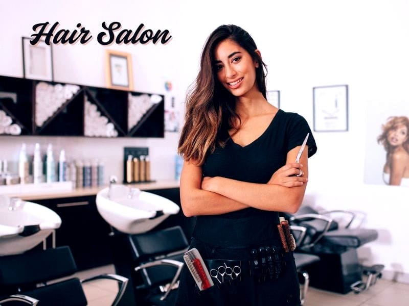 Confident hairstylist in a salon offering solutions for hair loss for women with expert care.