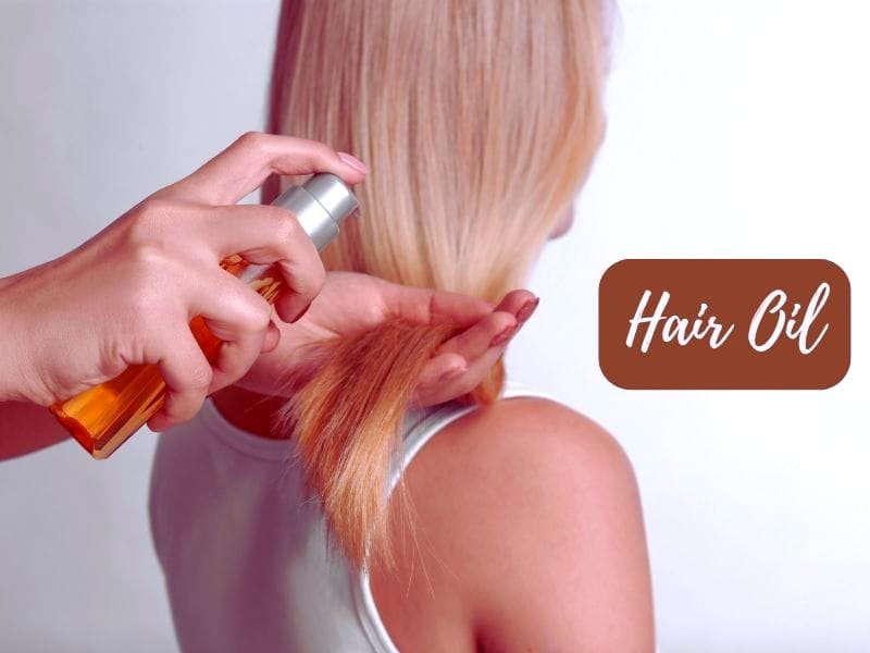 A person applying hair oil to blonde hair for nourishment and shine, promoting healthy hair care routines.