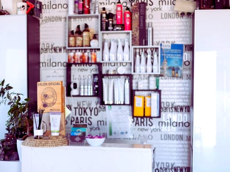 Professional hair care products on shelves, boosting salon revenue through product sales.