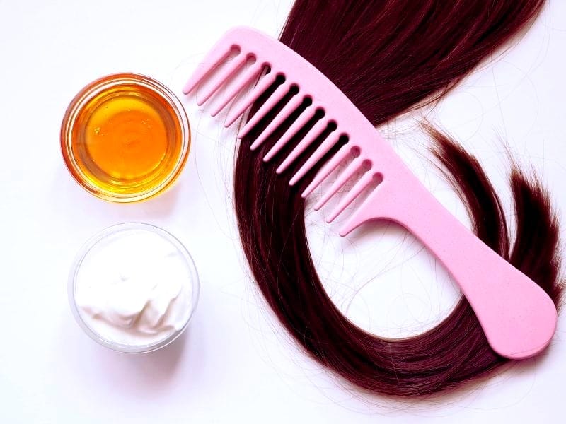 Natural remedies to fix dry hair using honey, deep-conditioning masks, and wide-tooth combs.