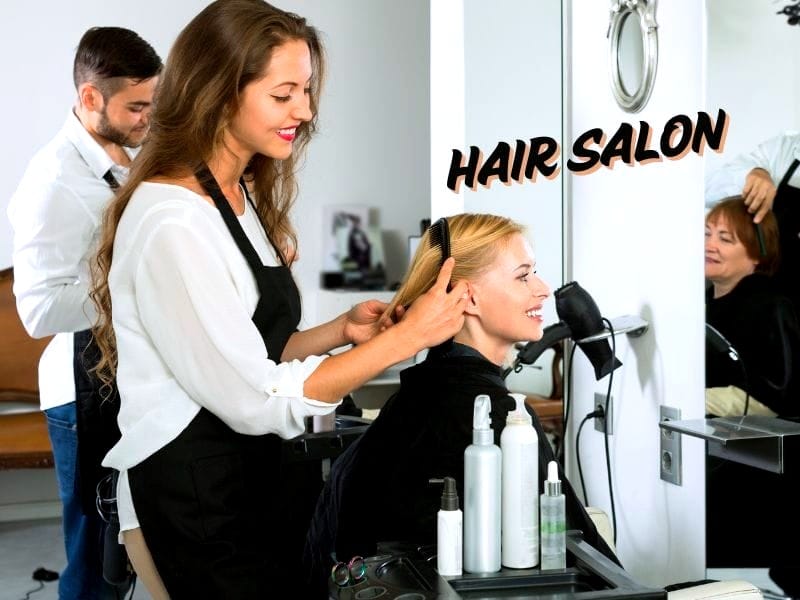 A smiling hairstylist combing a client's hair in a salon, showcasing a frizz-free strategy for smooth results, with text 'HAIR SALON' in bold, stylish font.