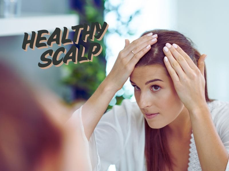 Healthy scalp care concept, woman inspecting hair for dandruff treatment.