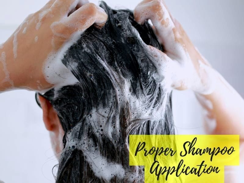 Person washing hair with foamy shampoo, hands massaging scalp, and yellow text "Proper Shampoo Application".