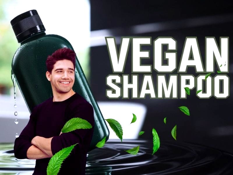 Smiling man with crossed arms in front of a green shampoo bottle labeled "VEGAN SHAMPOO," for scalp treatments surrounded by fresh green leaves.